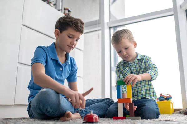 Concentré enfant impliqué unissant les briques de construction — Photo