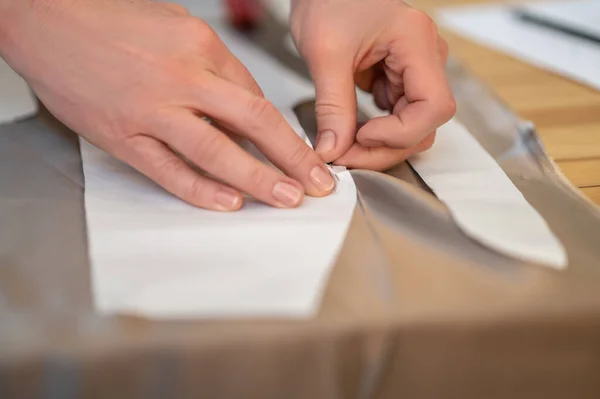 Hands of tailor stitching pattern with fabric — Stock Photo, Image