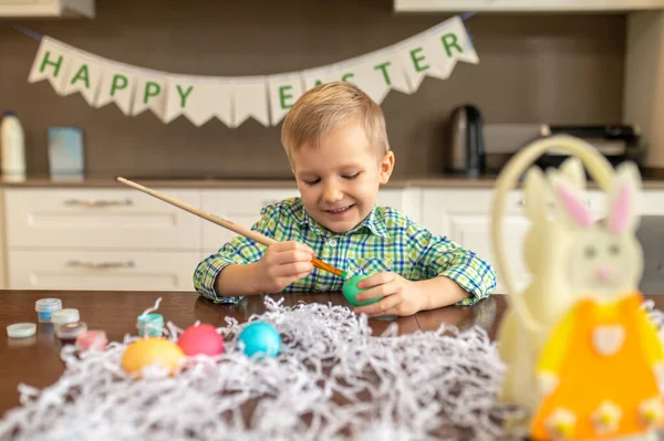Smiling happy focused kid preparing for Easter — Stock Photo, Image