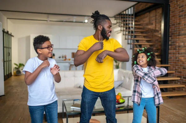 Man and children moving their hands in same way — Stock Photo, Image