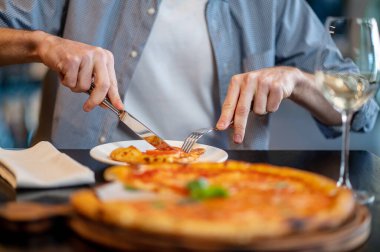 Pizza kesen bir annenin yakın plan fotoğrafı.