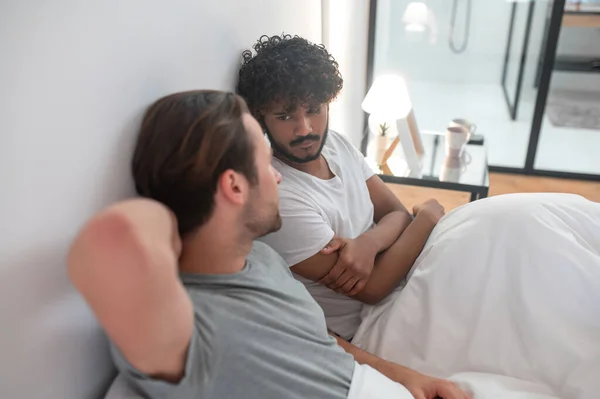 Сосредоточенный молодой мужчина смотрит на своего партнера во время разговора — стоковое фото