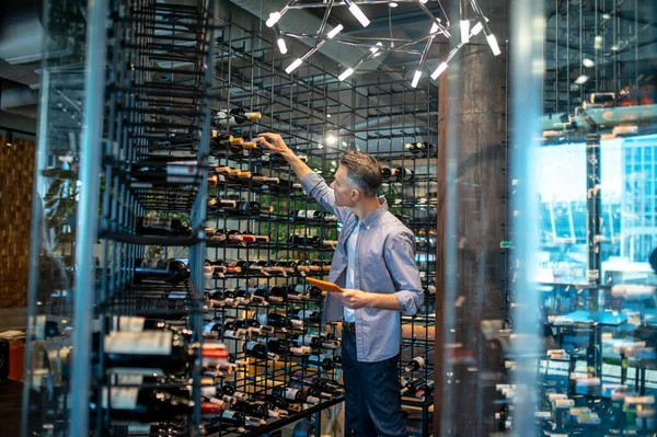 A wine store owner making a revision and looking busy — Stock Photo, Image