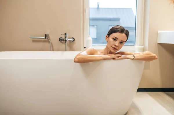 浴槽の中でカメラのためにポーズ平和女性 — ストック写真