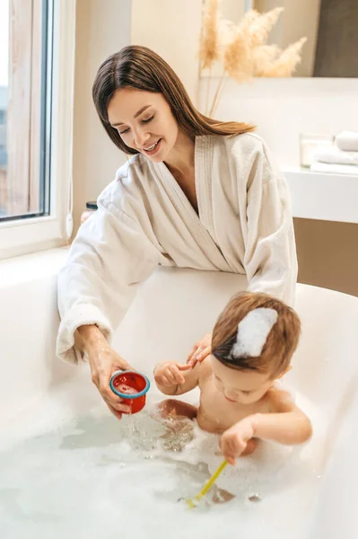 Glückliche Mutter spielt mit ihrem kleinen Jungen im Badezimmer — Stockfoto