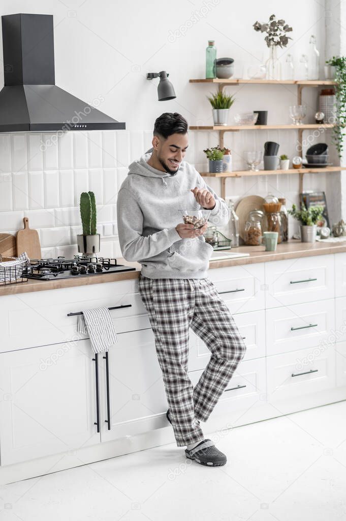 A young man spending morning at home and having coffee