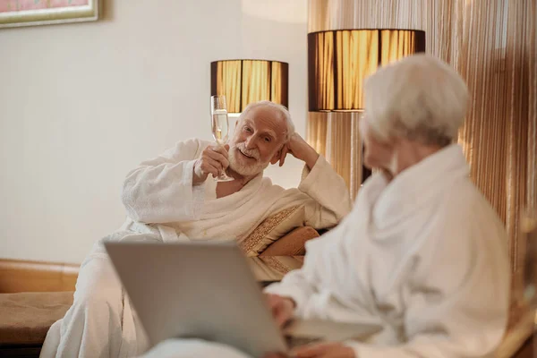 A senior couple searching for something on internet and looking interested — Foto de Stock