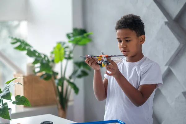 African american teen with a toy helicopter in hands — 스톡 사진