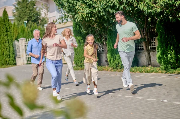 Smiling family running and enjoying time together — Stock Photo, Image