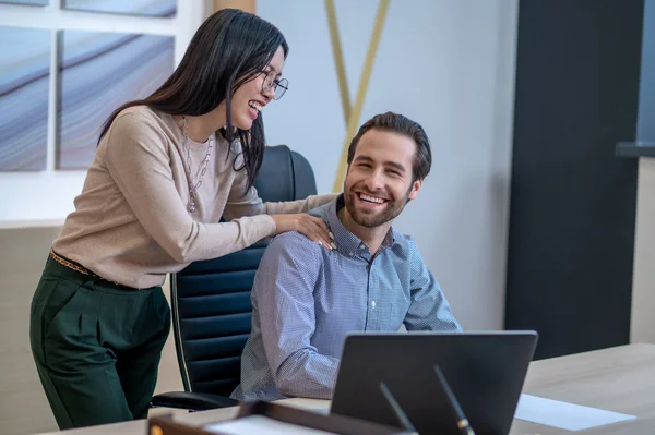 Cheerful personal assistant flirting with her director in his office — ストック写真