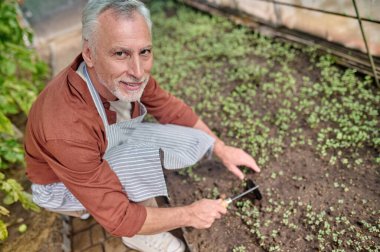 Adamın seradaki kameraya bakışının en üst görüntüsü
