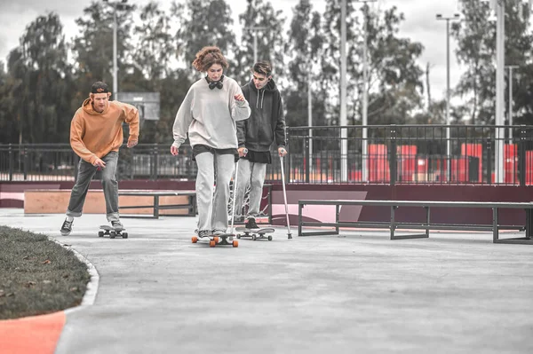 Young people and guy with disability riding skateboards — Φωτογραφία Αρχείου