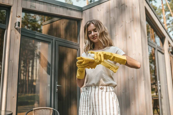 Smiling Focused Young Woman Rubber Gloves Applying Fluid Spray Bottle — Stock Photo, Image