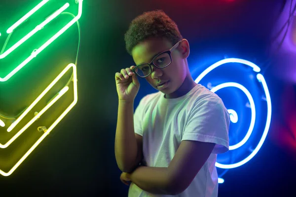 Gözlüklü Bir Gencin Belden Yukarı Portresi Neon Işıklara Karşı Kameraya — Stok fotoğraf