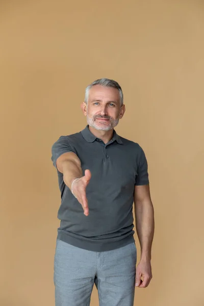Confiança Homem Com Uma Tshirt Cinzenta Esticando Braço Para Frente — Fotografia de Stock