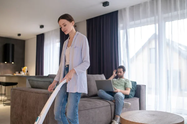 Housework Pretty Young Woman Vacuum Cleaner Cleaning Floor Man Working — Stock Photo, Image