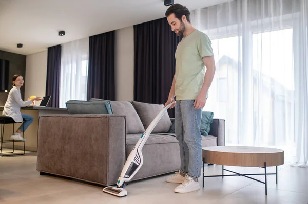 House Cleaning Young Bearded Man Sideways Camera Vacuuming Floor Woman — Stock Photo, Image