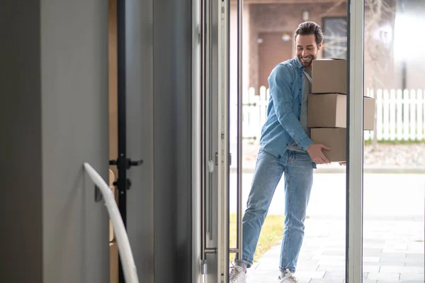 Moving Young Adult Smiling Man Holding Stack Boxes Looking Propping — Stock Photo, Image