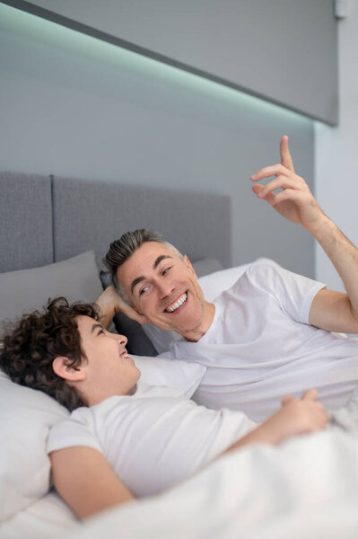 Morning Father Son Talking Bed Morning Looking Cheerful Royalty Free Stock Images