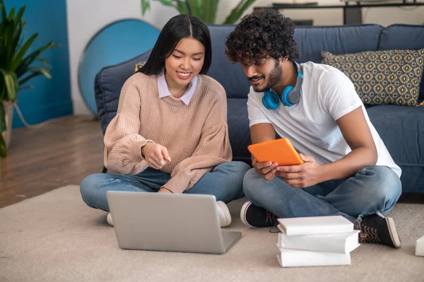 Studying together. Young people studying together and looking involved