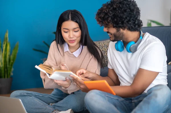 Studying together. Young people studying together and looking involved