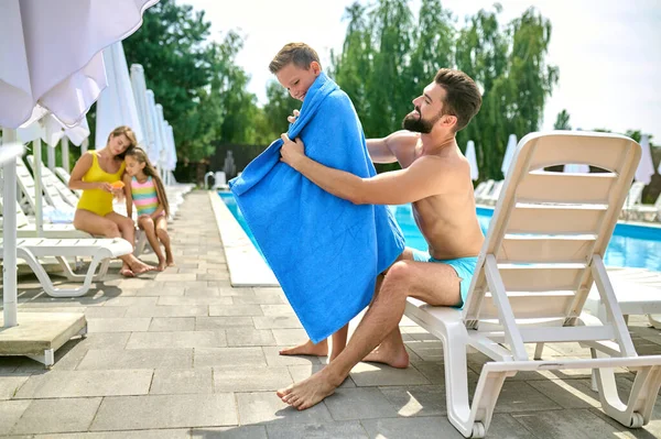 Caring Father Seated Sunlounger Wrapping Smiling Kid Towel Swimming — Stock Photo, Image