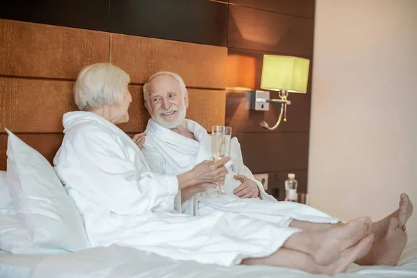 Anniversary celebration. Senior couple celebrating their wedding anniversary and having champaign