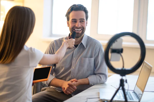 Interview Long Haired Woman Holding Microphone While Smiling Bearded Man — Foto de Stock