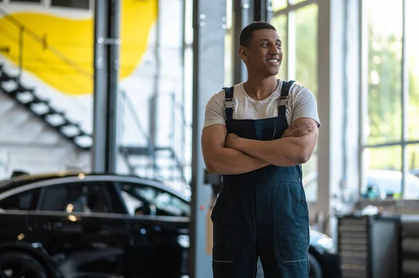 Cheerful Young Car Mechanic Overalls Standing Service Station Looking Away — Photo