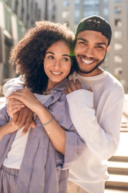 Happiness. Lovely young couple in sunlight looking happy