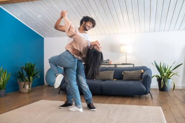 Dancers. Cute young couple looking happy while dancing