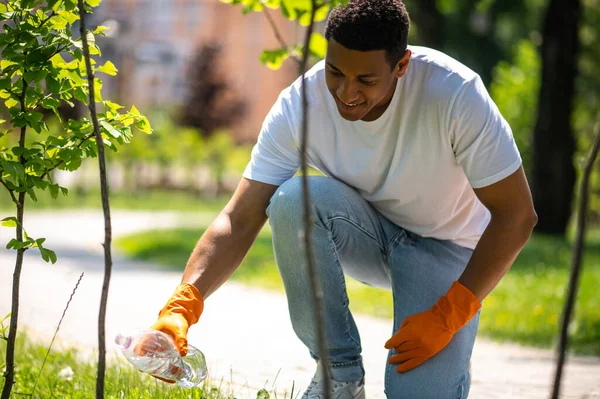 Volunteering Happy Dark Skinned Guy Protective Gloves Watering Tree Seedlings —  Fotos de Stock