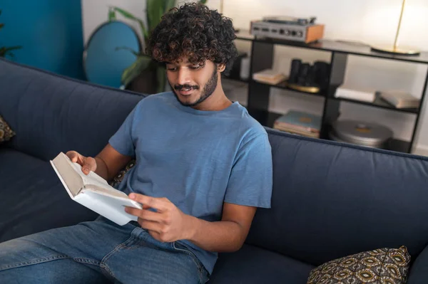 Reading Book Curly Haired Indian Guy Reading Book Looking Involved — Foto de Stock