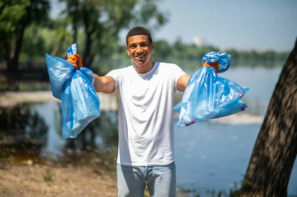 Social Position Smiling Dark Skinned Confident Guy Showing Garbage Bags — Foto de Stock