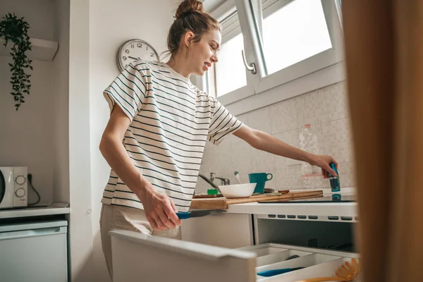 Focused Female Cook Knife One Hand Standing Open Cabinet Drawer — Stockfoto