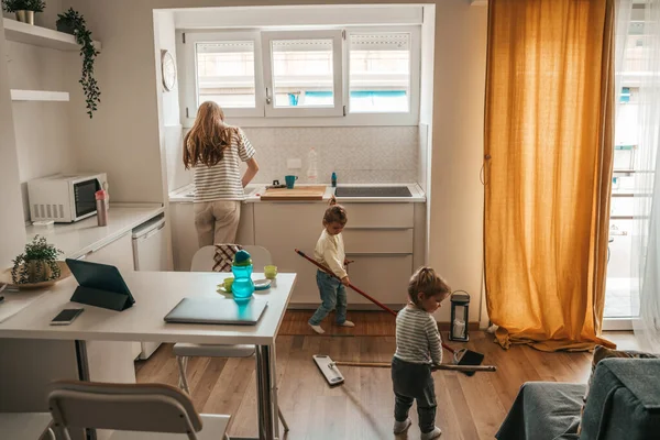 Cute Little Girls Sweeping Kitchen Floor Mops While Female Parent — Stockfoto