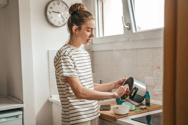 Focused Beautiful Young Female Putting Cooked Oatmeal Pot Ceramic Bowl — Foto de Stock