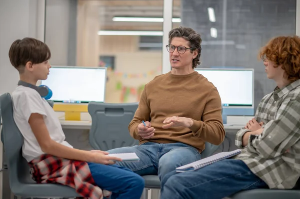 Interesting information. Boys sitting next to teacher and looking interested