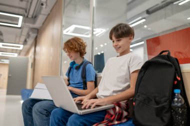 Studying together. Two school friends getting ready for the lesson