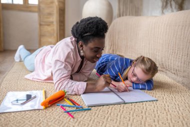Lesson. A cute girl writing something and looking involved