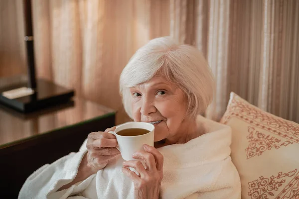 Happy Morning Waistup Senior Woman Having Morning Tea Bed — Stok fotoğraf