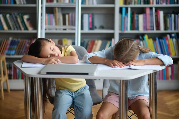 Exhausted Modern Teenage Girl Her Friend Sleeping Table Reading Room —  Fotos de Stock