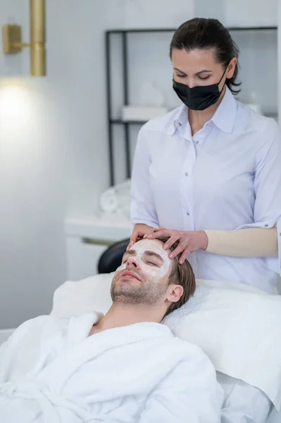 Facial Mask Female Specialist Applying Facial Mask Mans Face — Photo