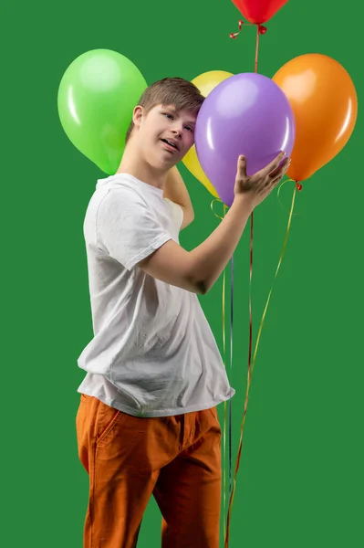 Teen Syndrome Touching Bunch Inflated Bright Colorful Balloons Looking Ahead — Stockfoto