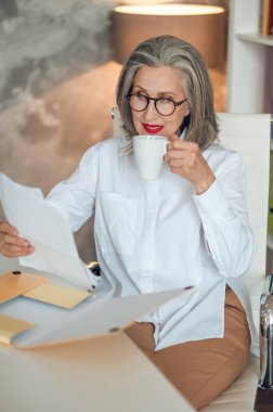 In the office. Well-dressed and good-looking businesswoman in the office