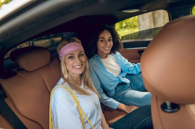 On the way. Young people in the car looking happy and contented