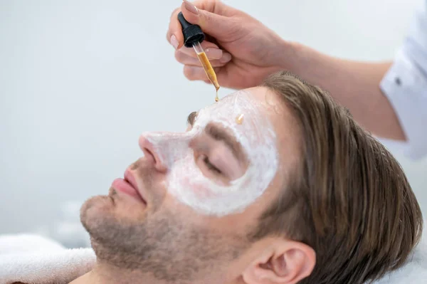 Eye Mask Professional Cosmetologist Applying Hydrating Mask Mans Eye Area — Fotografia de Stock