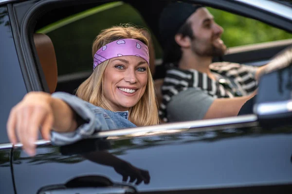 Good mood. A couple in the car looking happy and cheerful