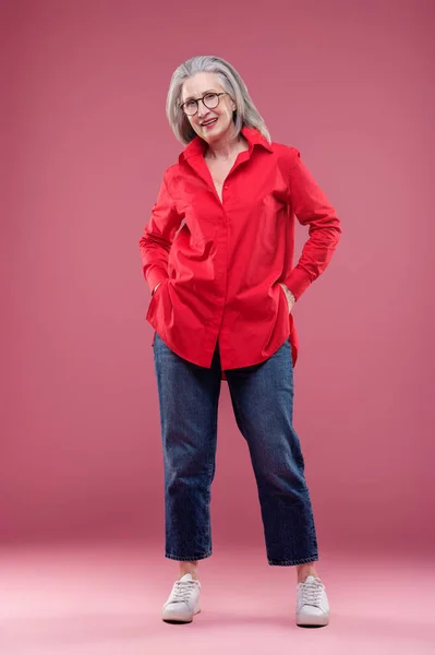 Feel Good Mature Woman Red Shirt Looking Contented — Zdjęcie stockowe