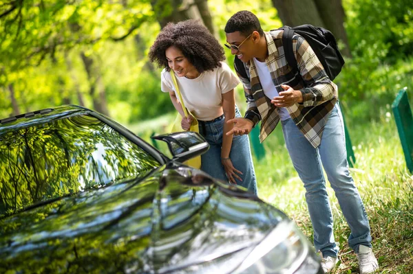 Hitchhikers. Two young people on te road asking the way to the city
